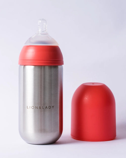 Bottle with red cap and silver body on a white background