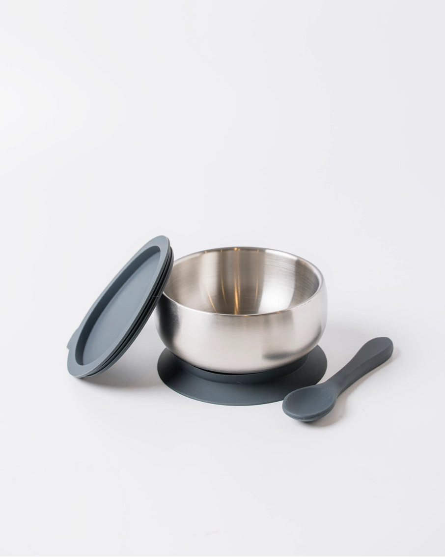 Silver bowl with black lid and spoon on a white background
